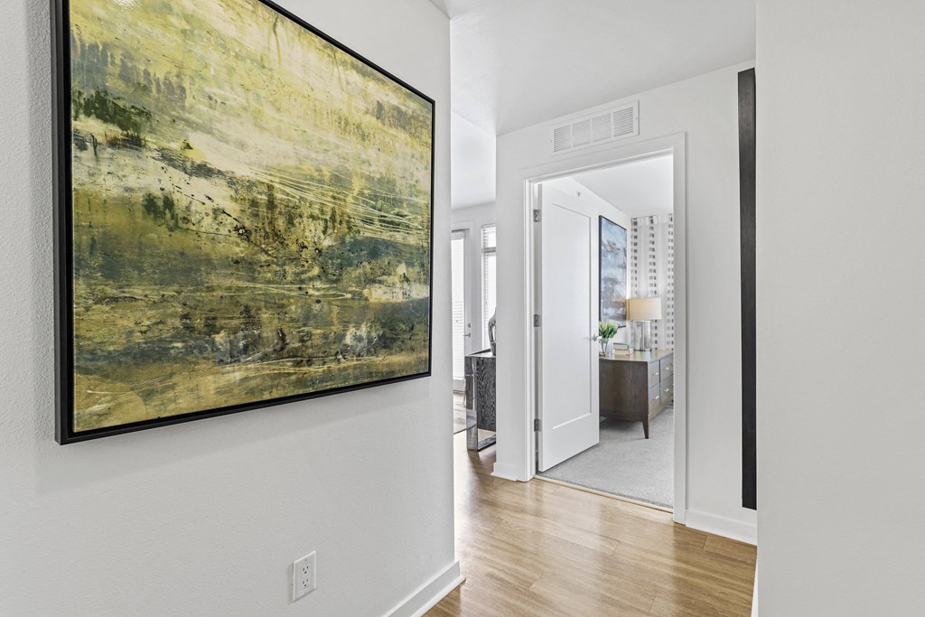 a hallway with a large painting on the wall