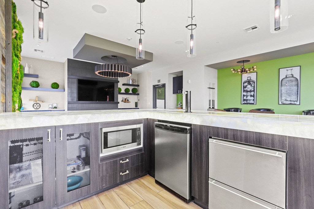 a kitchen with gray cabinets and green walls at Union West Apartments, Lakewood