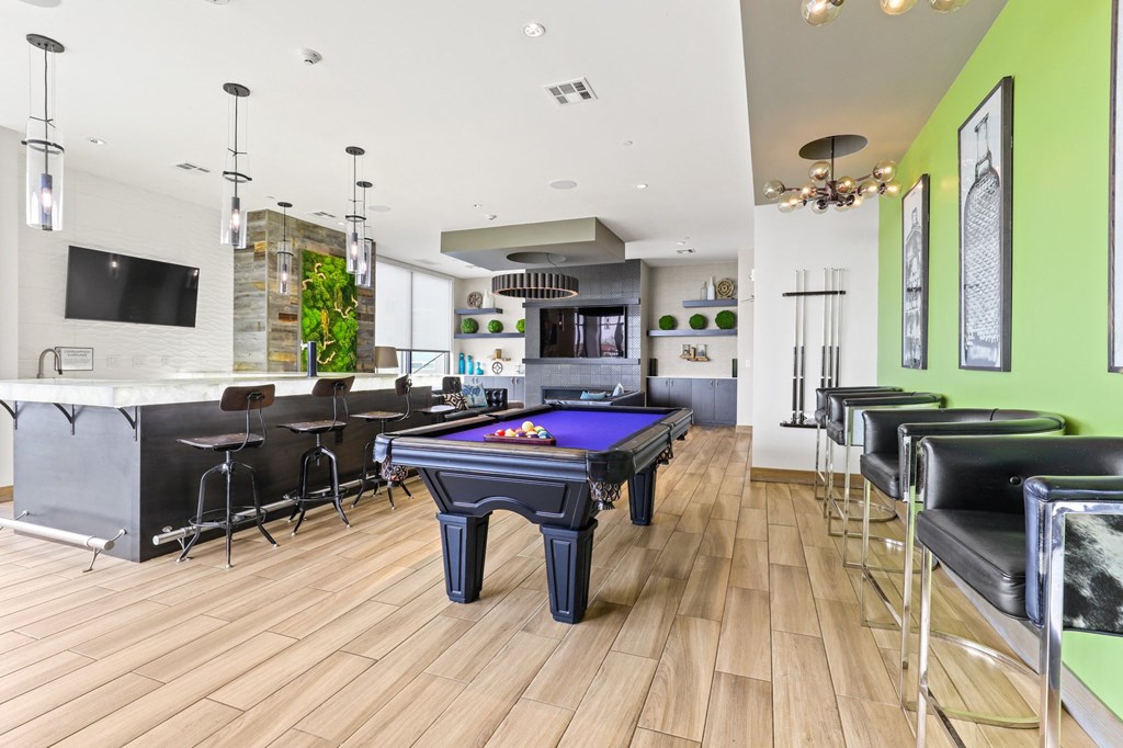 a game room with a pool table and bar at Union West Apartments, Lakewood, 80228