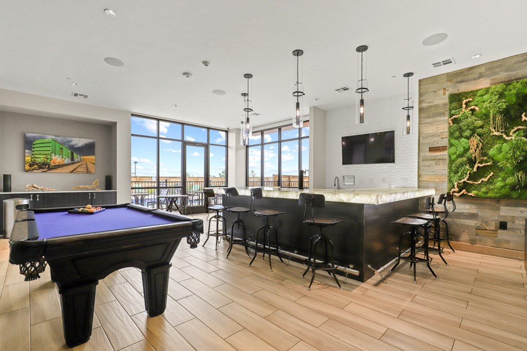 a large room with a pool table and a bar at Union West Apartments, Lakewood, CO 80228