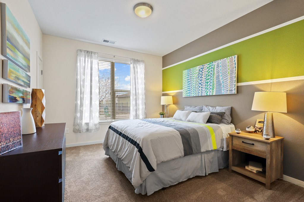 a bedroom with a bed and two windows