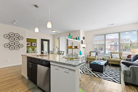 our apartments offer a living room with a kitchen and dining area at WestLink at Oak Station, Lakewood