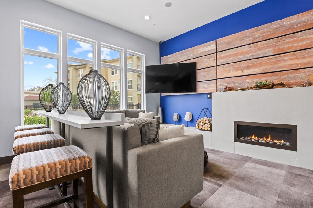 a living room with a blue accent wall and a fireplace