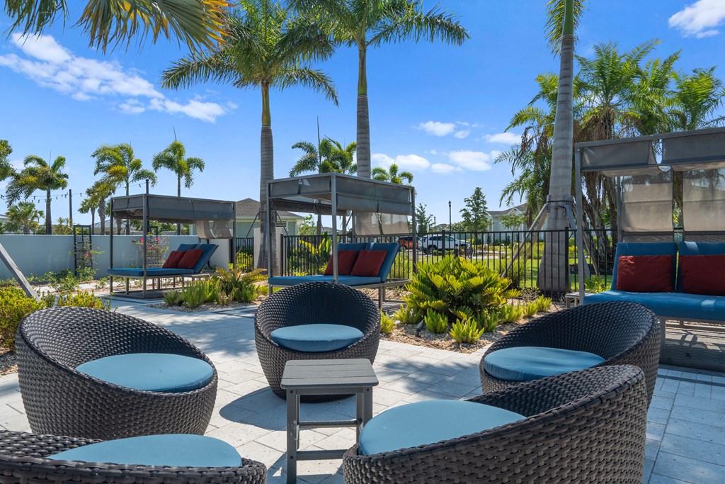 blue and brown chairs positioned around table outdoors at Artesia at Lakewood Ranch Apartments, Bradenton, 34211