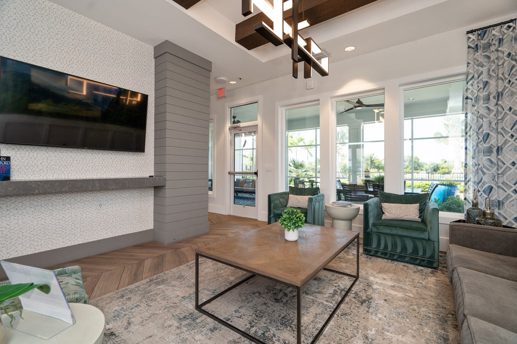 a living room with a coffee table and a television at Artesia at Lakewood Ranch Apartments, Bradenton