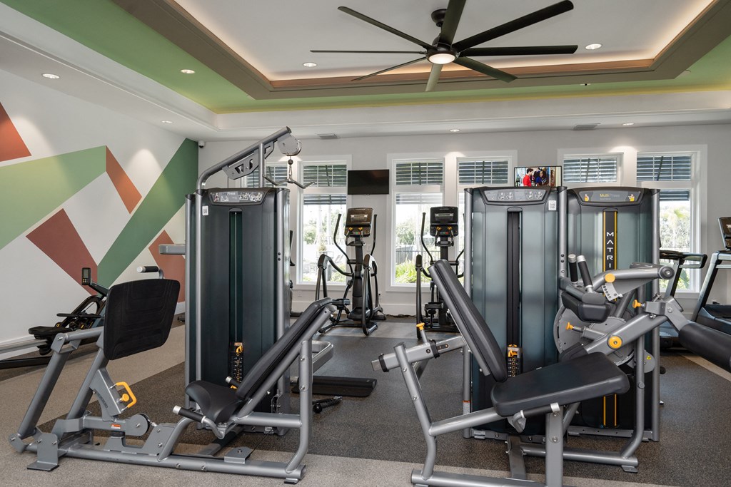 a gym with treadmills and other exercise equipment in a hotel room at Artesia at Lakewood Ranch Apartments, Florida 34211