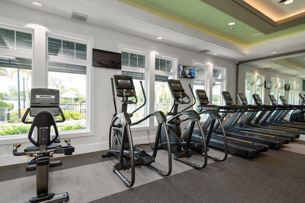 the gym at the inn atrium has cardio equipment and windows at Artesia at Lakewood Ranch Apartments, Bradenton