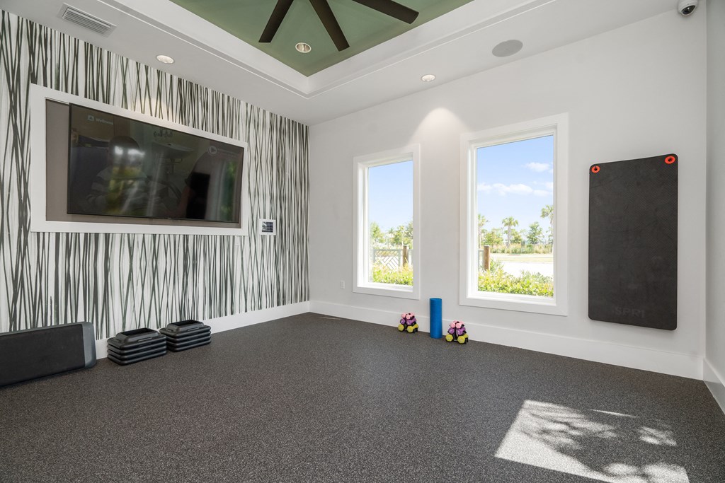 a room with a large screen on the wall and a projector on the floor at Artesia at Lakewood Ranch Apartments, Bradenton, Florida