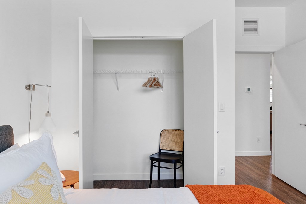 a bedroom with a bed and a chair and a closet at Odyssey, Fort Myers, FL, 33905