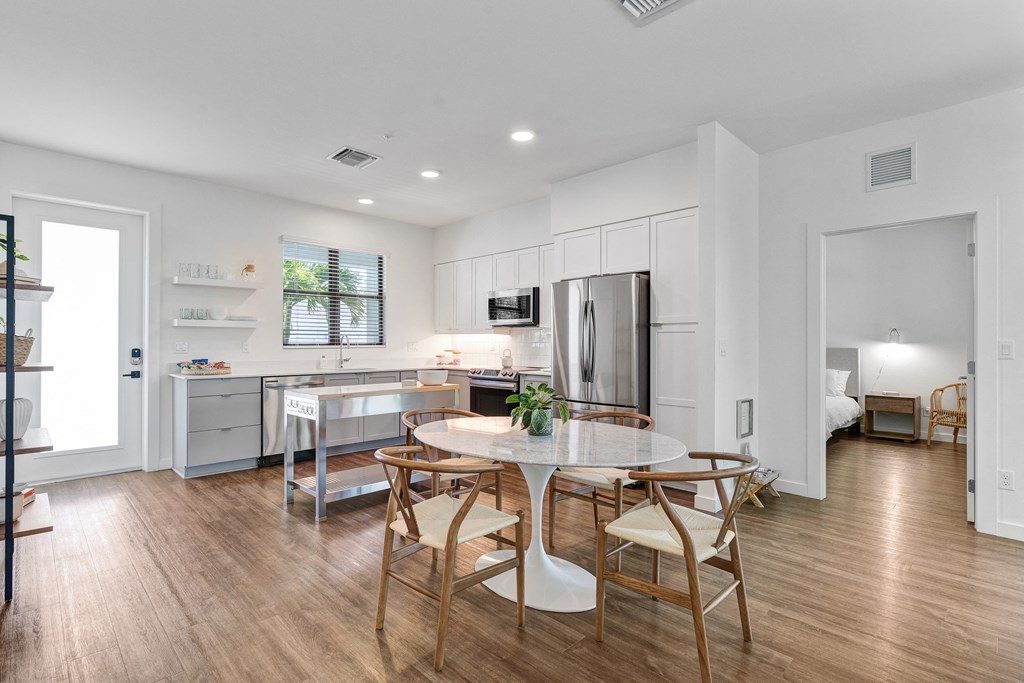 a kitchen and dining room with a table and chairs at Odyssey, Fort Myers, Florida
