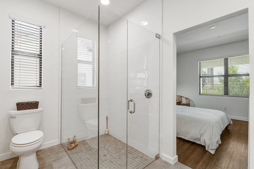 a bathroom with a shower and a bed at Odyssey, Fort Myers, Florida