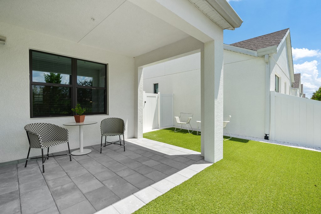 a patio with two chairs and a table on a patio at Odyssey, Fort Myers, FL, 33905