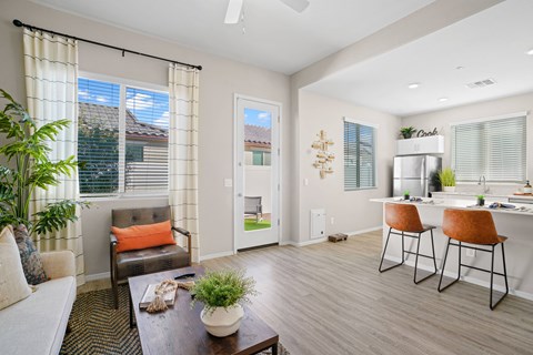A living room with a brown leather chair and a white couch.