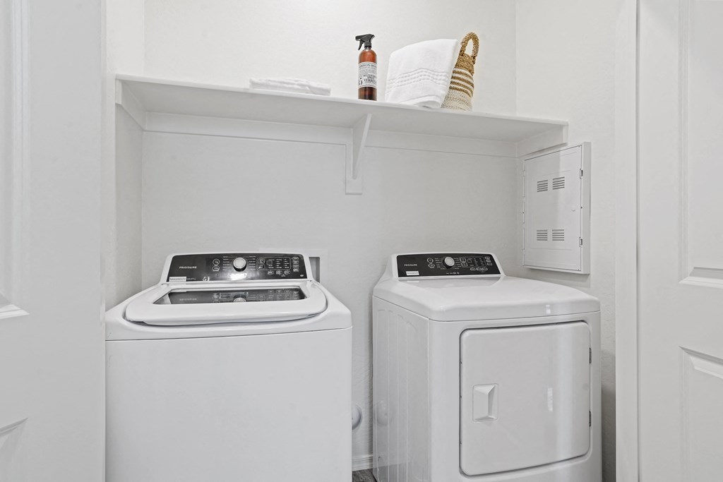 a small laundry room with two washes and a dryer at Sienna at South Mountain Apartments, Laveen, 85339
