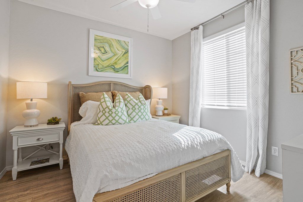 a bedroom with a large bed and a window at Sienna at South Mountain Apartments, Laveen, AZ, 85339