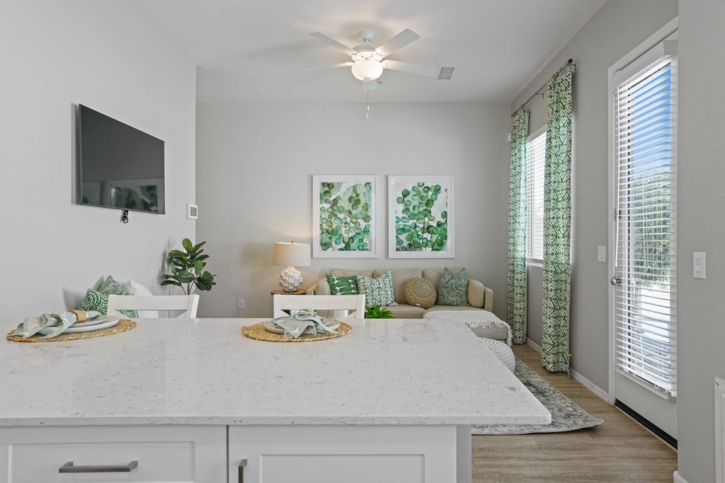 kitchen with white countertops facing couch at Sienna at South Mountain Apartments, Laveen, AZ, 85339