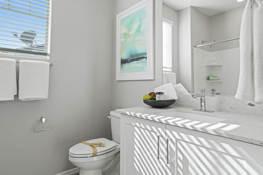 a white bathroom with a sink and a toilet at Sienna at South Mountain Apartments, Laveen, 85339