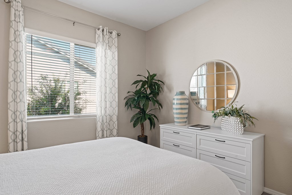 a bedroom with a large white bed and a window at Sienna at South Mountain Apartments, Arizona, 85339