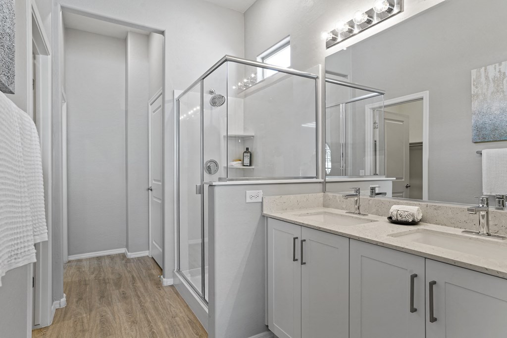 a bathroom with a shower and a sink and a mirror at Sienna at South Mountain Apartments, Arizona