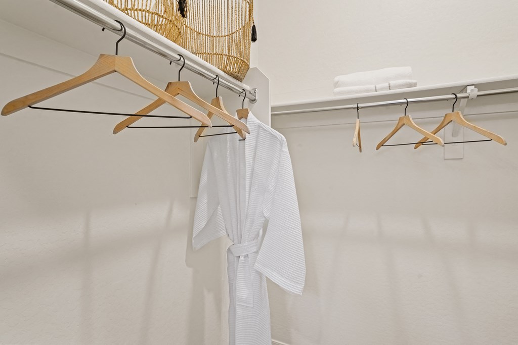 a closet with a white shirt hanging from a rack on the wall at Sienna at South Mountain Apartments, Laveen, AZ, 85339