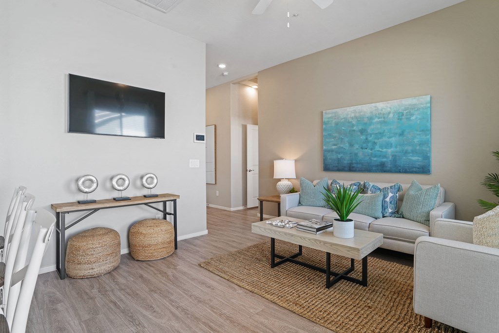a living room with a couch and a table at Sienna at South Mountain Apartments, Laveen, AZ, 85339