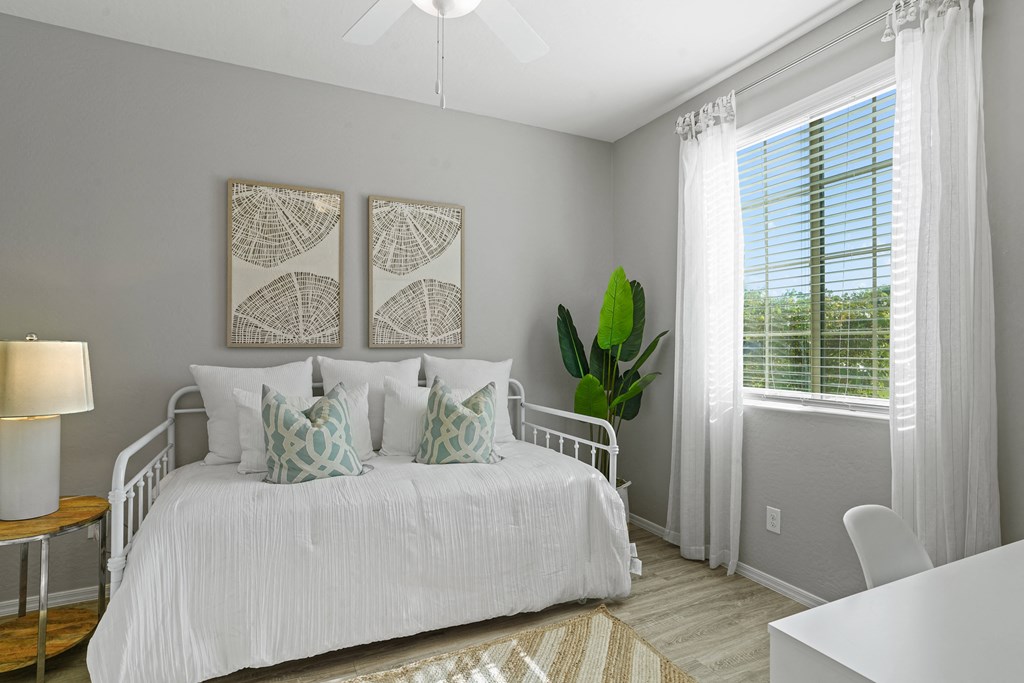 a bedroom with a white bed and two pictures on the wall at Sienna at South Mountain Apartments, Arizona, 85339