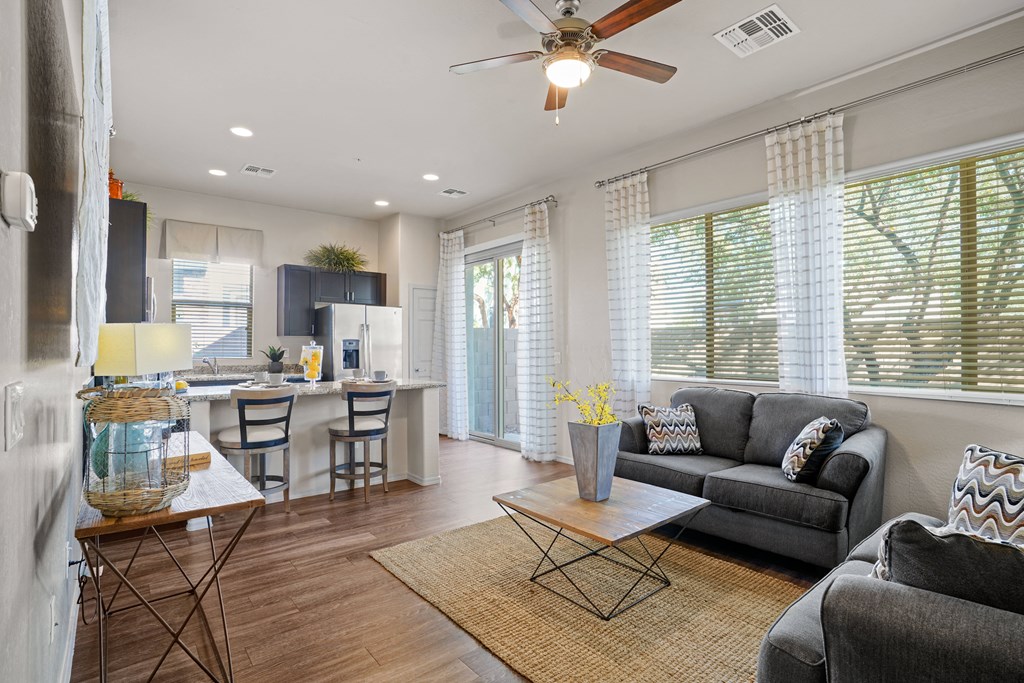 an open living room and kitchen with a ceiling fan