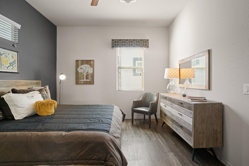 a bedroom with a bed and a dresser and a window