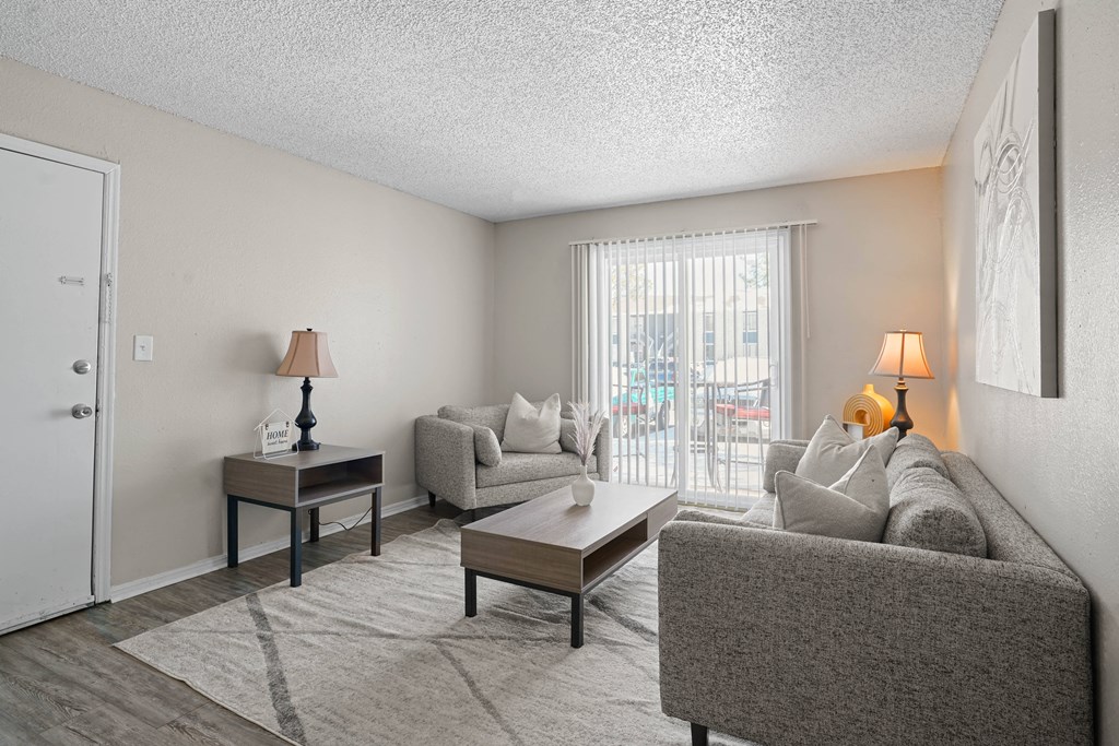 a living room with a couch and a table and a sliding glass door