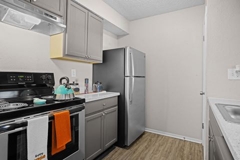 the preserve at ballantyne commons apartment kitchen with stainless steel appliances and a refrigerator