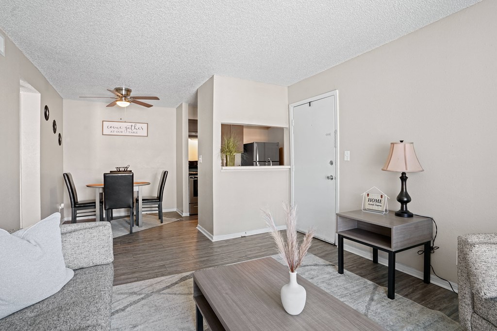 the living room and dining area of a apartment with a couch and a table