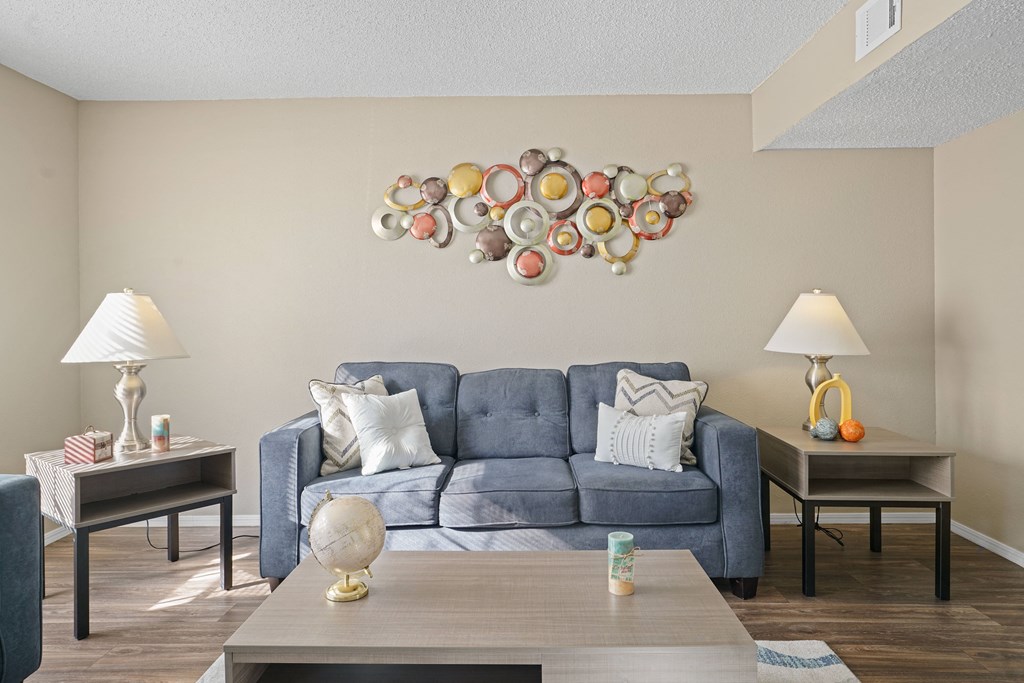 blue couch and brown table with two side tables