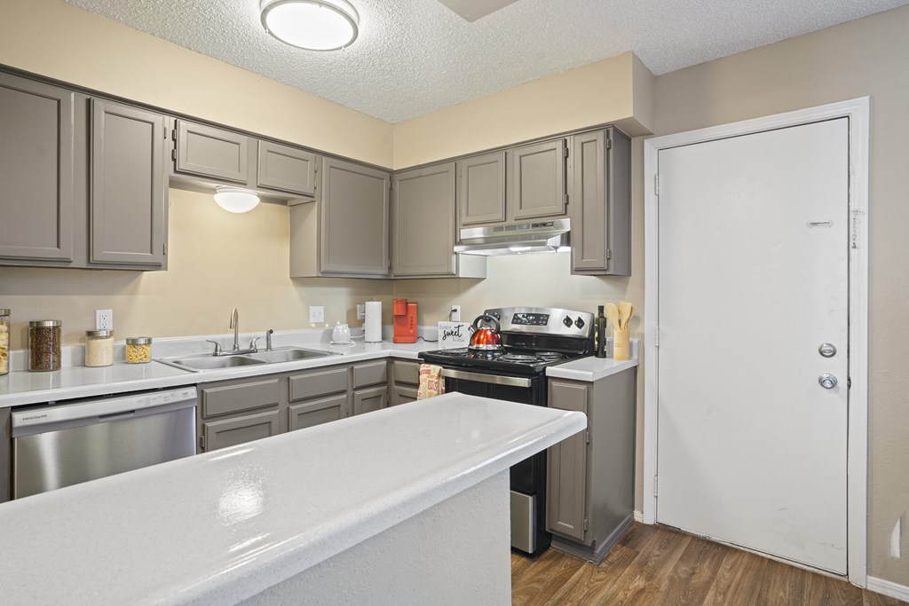 view looking into kitchen with breakfast bar and light brown cabinets