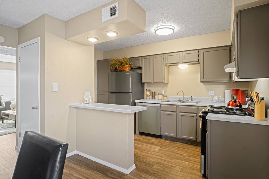 view looking into kitchen with breakfast bar and light brown cabinets