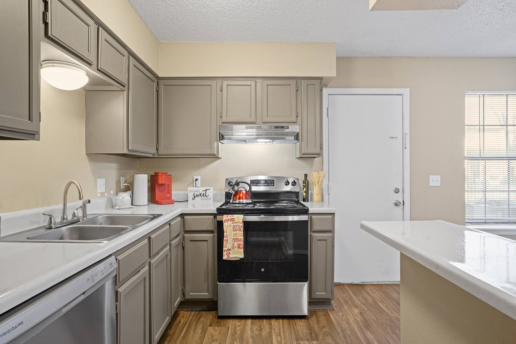 view looking into kitchen with breakfast bar and light brown cabinets