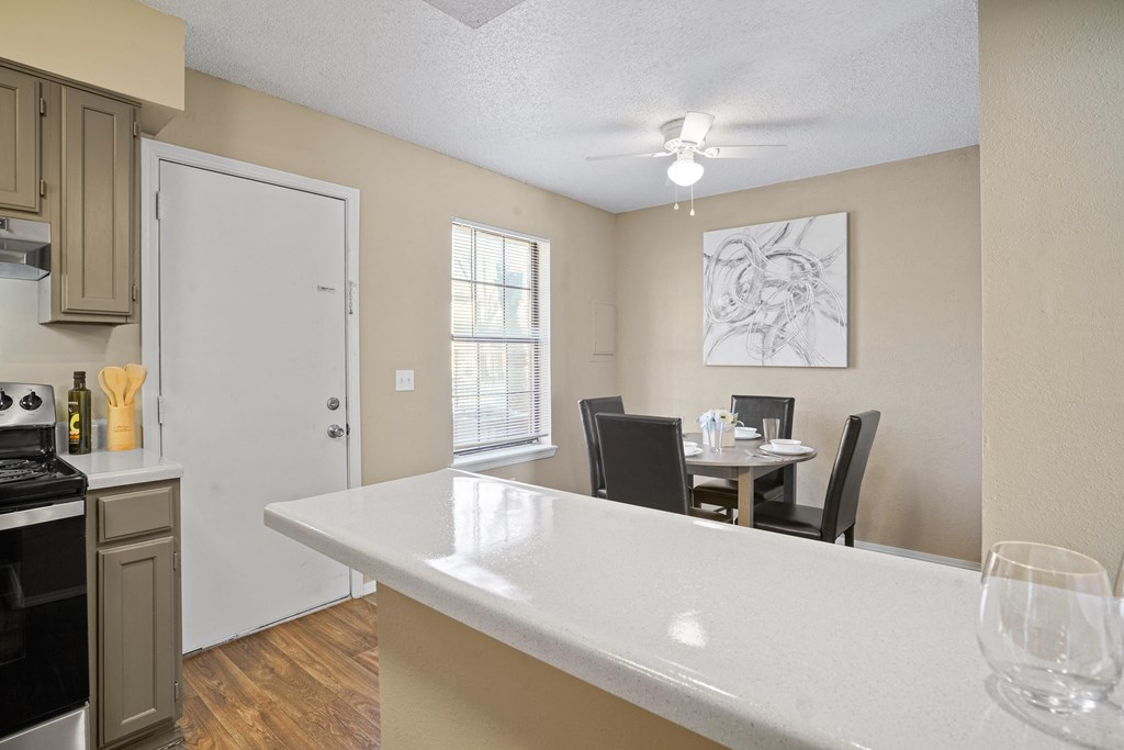 breakfast bar in kitchen with dining room area behind it