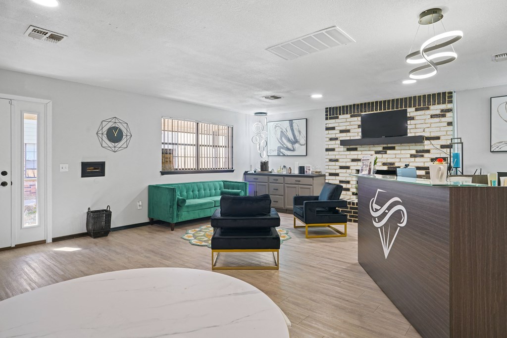 large room with desk, couch and chairs