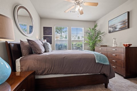 Bedroom with cozy bed Bedroom with cozy bed at The Millennium Towne Center Apartments, Baton Rouge, Louisiana