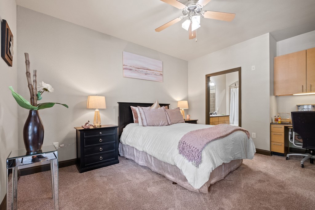 a bedroom with a bed and a ceiling fan at The Millennium Towne Center Apartments, Louisiana