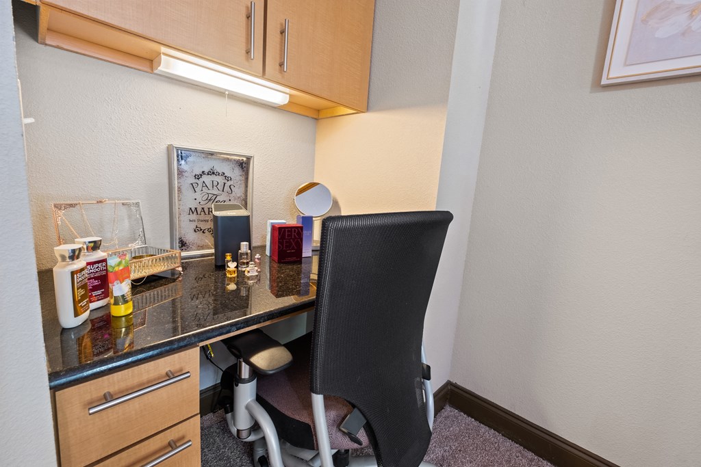 a desk with a chair in a small room with a counter top at The Millennium Towne Center Apartments, Baton Rouge, LA, 70806