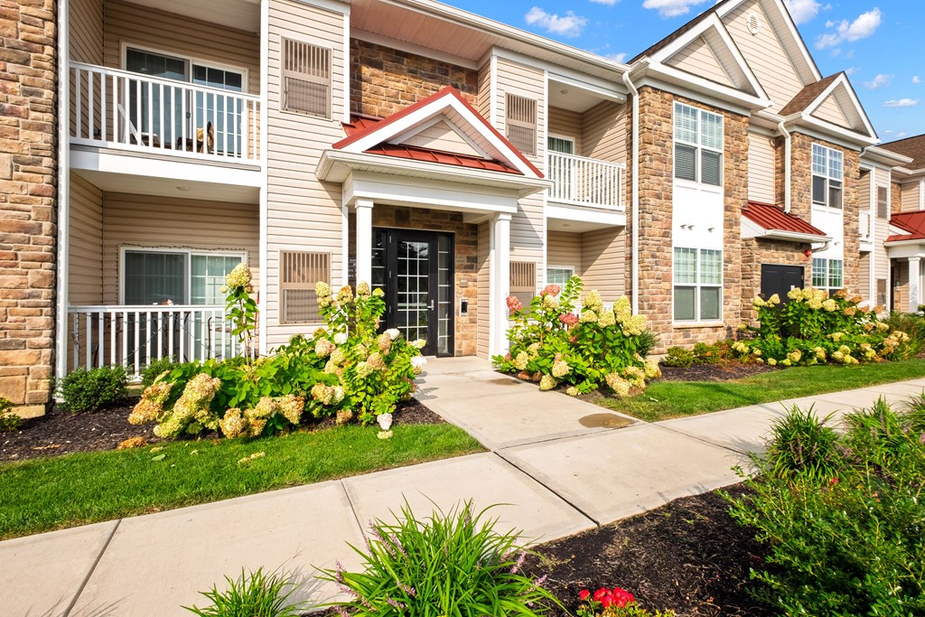 a sidewalk in front of an apartment building at The Landing Apartment , New Jersey, 07730