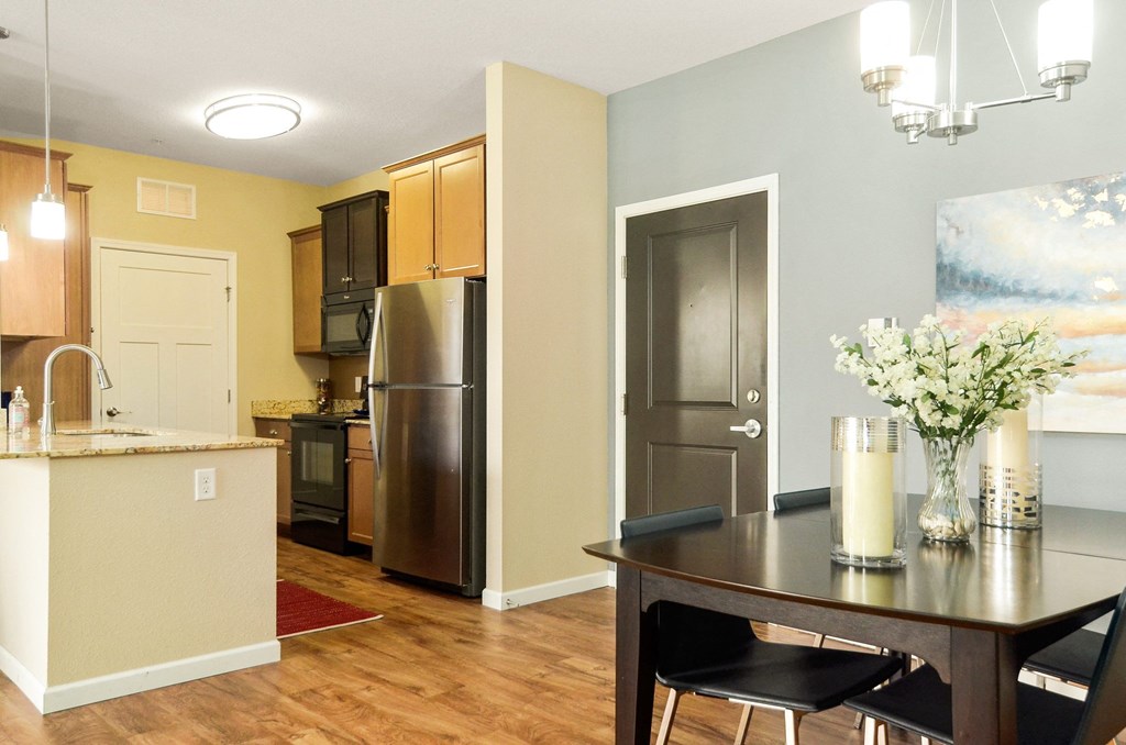 a kitchen and dining area in a 555 waverly unit at Skye at Arbor Lakes, Minnesota, 55369