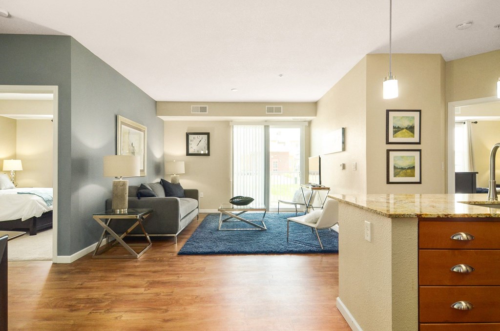 a living room with a couch and a table at Skye at Arbor Lakes, Maple Grove, MN