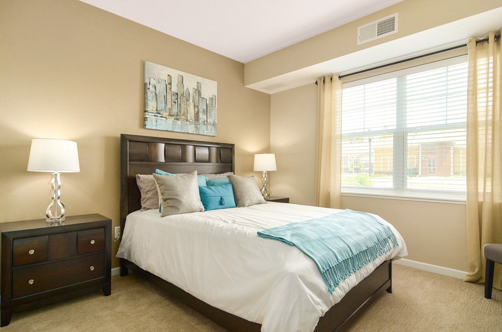 a bedroom with a bed and two night stands at Skye at Arbor Lakes, Maple Grove, 55369