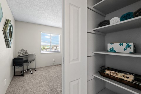 a bedroom with a desk and shelves at Park 88 Apartments, Thornton, 80229