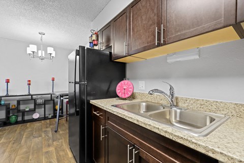 a kitchen with a sink and a refrigerator at Park 88 Apartments, Thornton