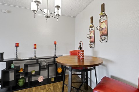 a dining area with a table and chairs and a chandelier at Park 88 Apartments, Colorado