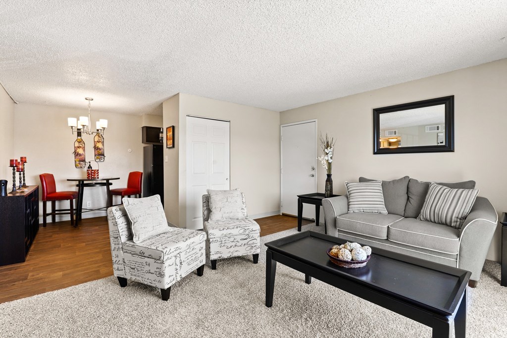 a living room with a couch and two chairs