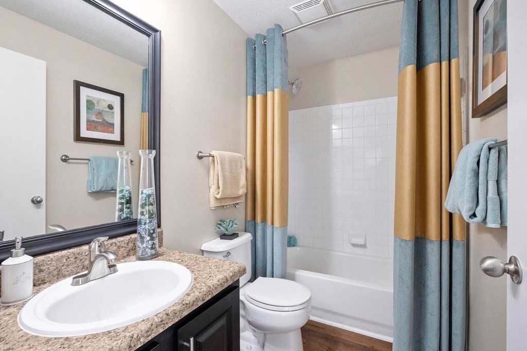 a bathroom with a shower toilet and sink and a mirror at 150 Summit, Alabama