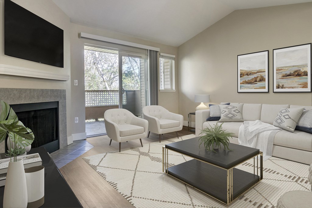 a living room with a couch chair coffee table and fireplace